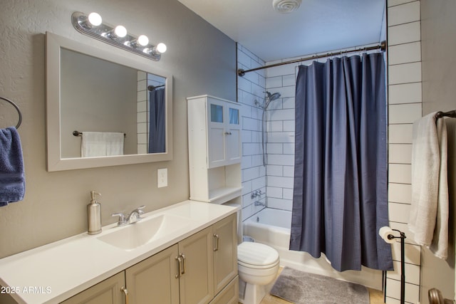 bathroom featuring toilet, shower / bath combo, and vanity