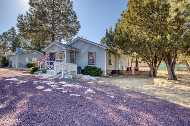 view of front of house featuring fence