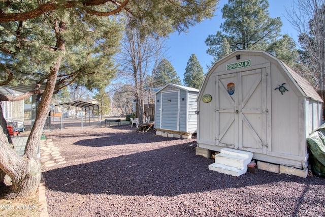 view of shed featuring a detached carport and fence