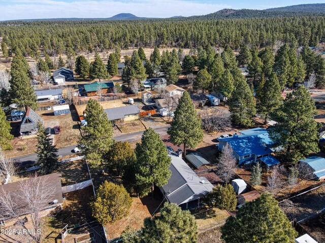 aerial view with a view of trees and a mountain view