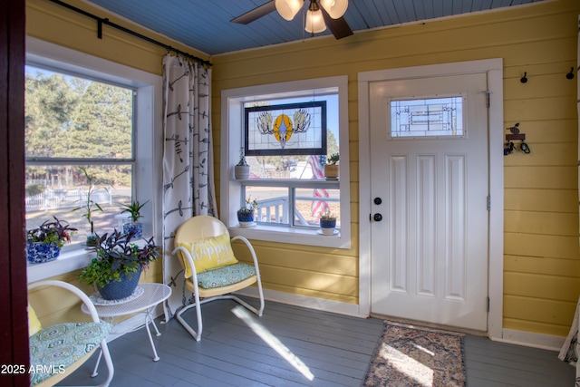 sunroom featuring a ceiling fan