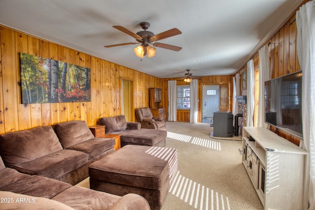 living area with wooden walls and carpet flooring