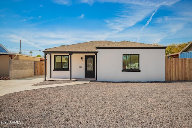 single story home with fence and stucco siding