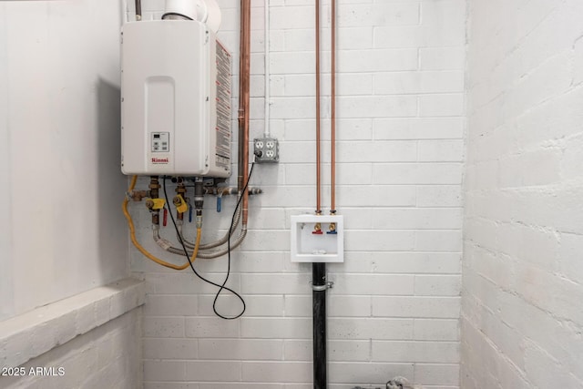 utility room with tankless water heater