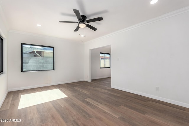 spare room featuring ceiling fan, ornamental molding, and dark hardwood / wood-style flooring