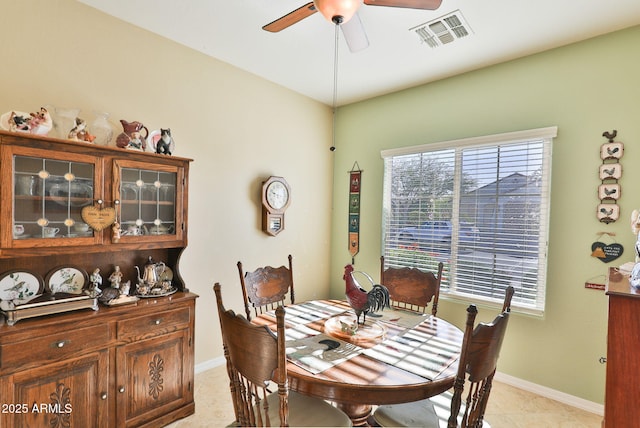 dining area with a healthy amount of sunlight, light tile patterned floors, ceiling fan, and visible vents