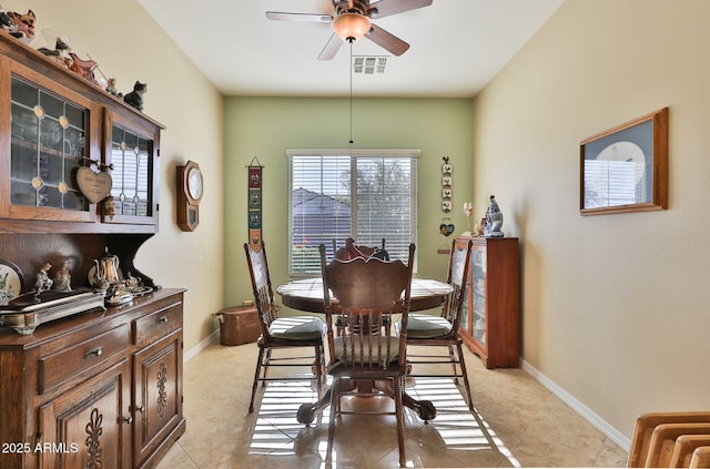 dining space featuring baseboards, visible vents, and light tile patterned flooring