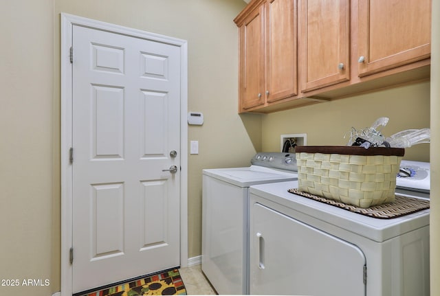 laundry room featuring cabinet space, washer and clothes dryer, and light tile patterned floors