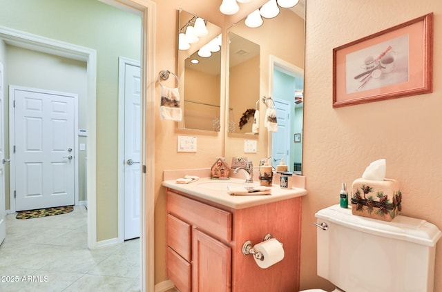 bathroom with vanity, toilet, and tile patterned floors