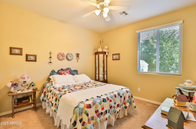 carpeted bedroom featuring baseboards, visible vents, and a ceiling fan