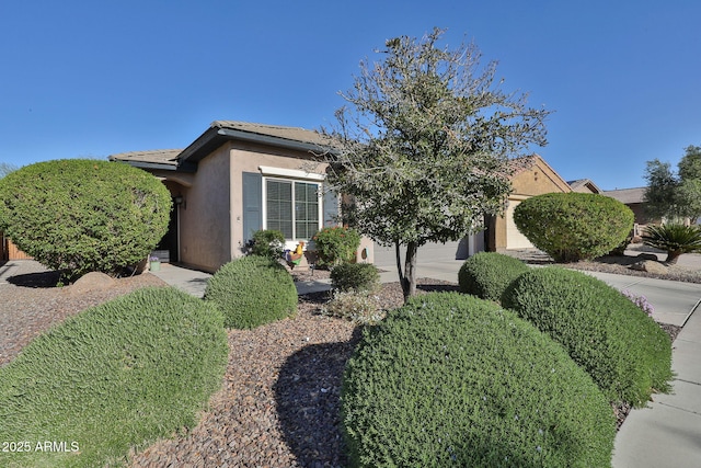 view of front of property featuring a garage and stucco siding