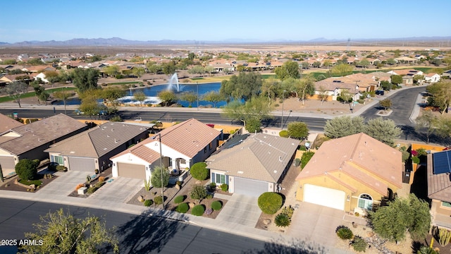 birds eye view of property with a residential view and a water and mountain view