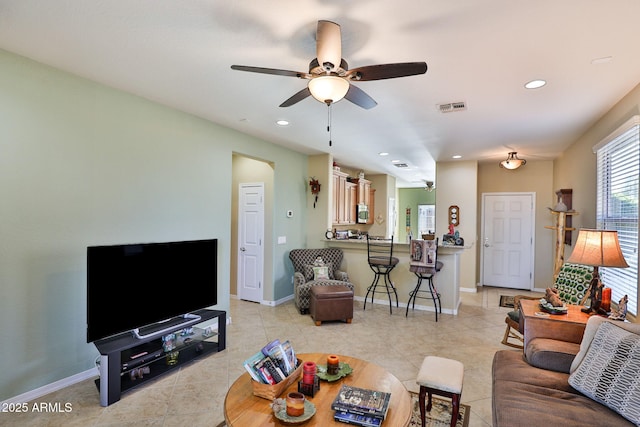 living room featuring recessed lighting, visible vents, baseboards, and light tile patterned floors