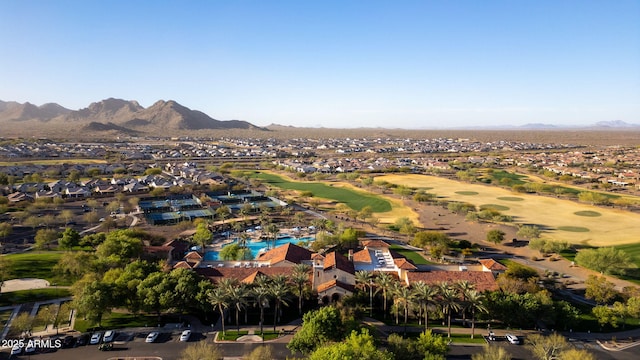 bird's eye view with view of golf course and a mountain view