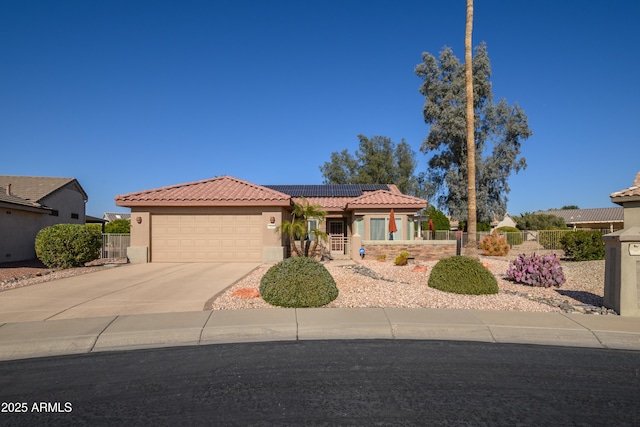 view of front of home with a garage and solar panels