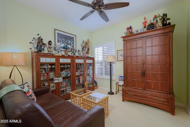 carpeted living room featuring ceiling fan