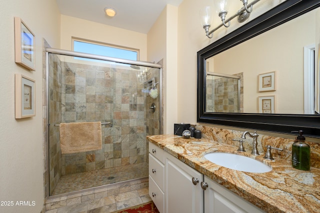 bathroom featuring vanity and an enclosed shower