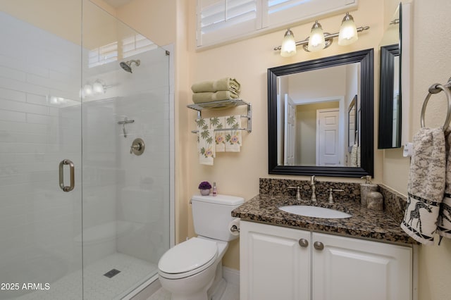 bathroom featuring an enclosed shower, vanity, and toilet