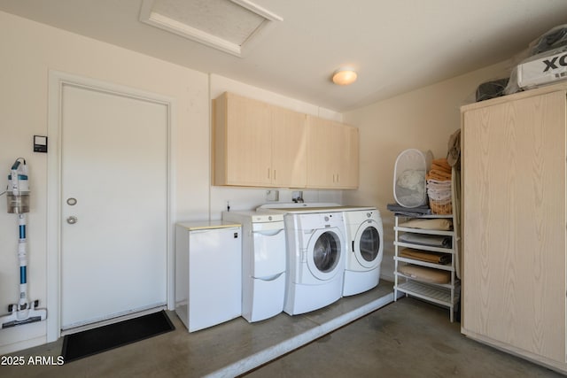 laundry room featuring cabinets and washer and dryer