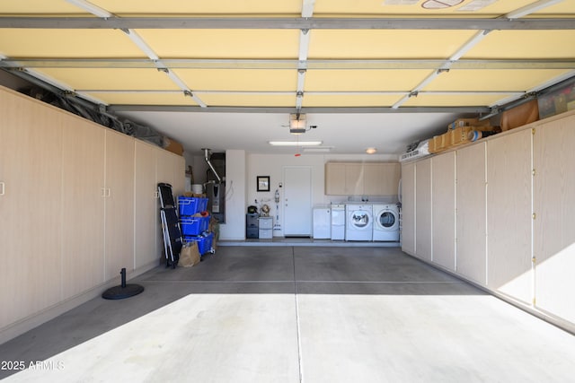 garage featuring a garage door opener and washer and clothes dryer