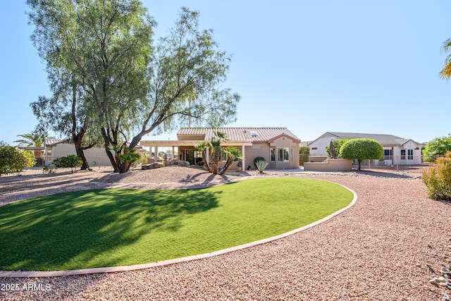 mediterranean / spanish house featuring a front lawn