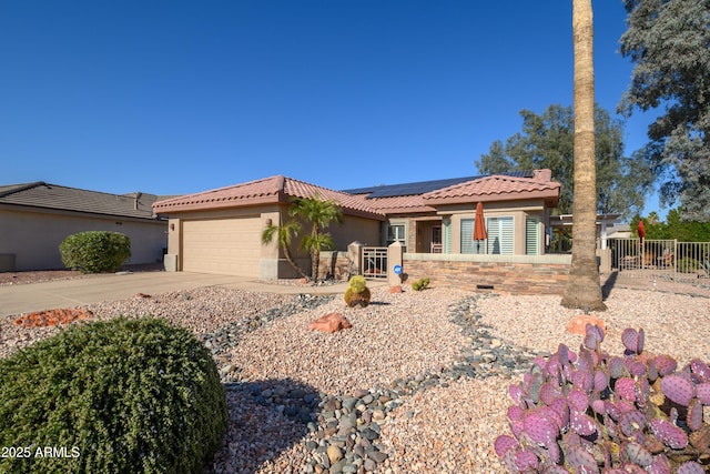 view of front of property with a garage and solar panels