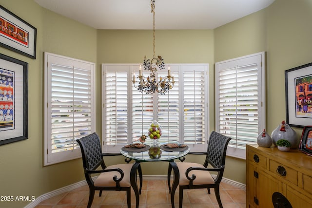 dining area with an inviting chandelier and light tile patterned flooring