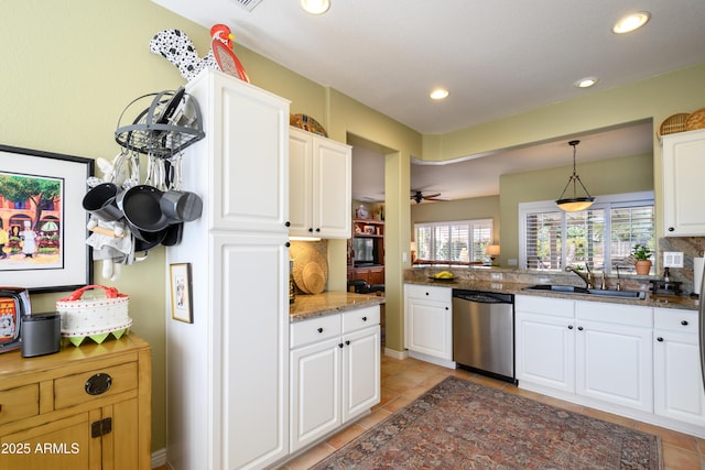 kitchen featuring pendant lighting, sink, dishwasher, white cabinets, and decorative backsplash