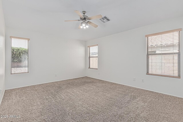 708 E Mule Train Trl, San Tan Valley, AZ 85143 - carpeted empty room featuring ceiling fan, visible vents, plenty of natural light, and baseboards