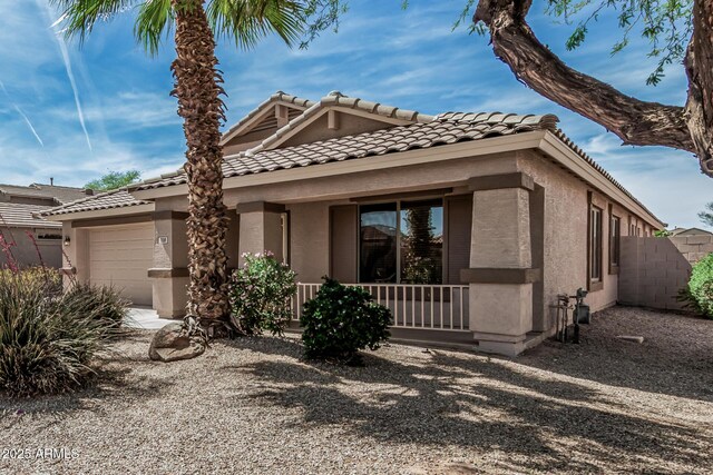 708 E Mule Train Trl, San Tan Valley, AZ 85143 - view of front of home with a porch, a garage, stucco siding, and a tiled roof