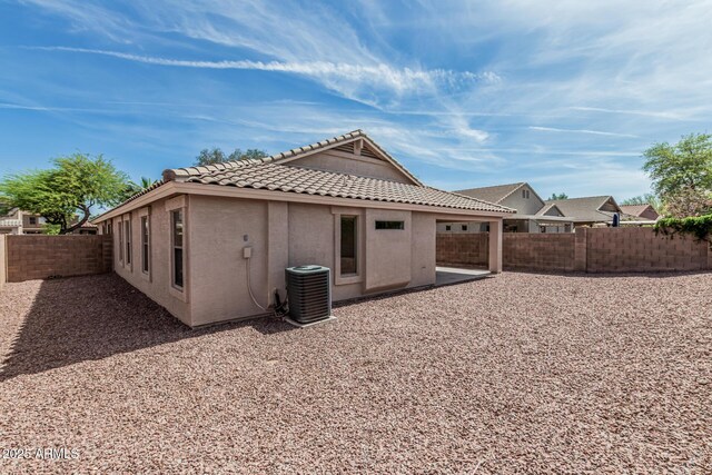 708 E Mule Train Trl, San Tan Valley, AZ 85143 - rear view of house featuring stucco siding, a fenced backyard, central AC, and a tile roof