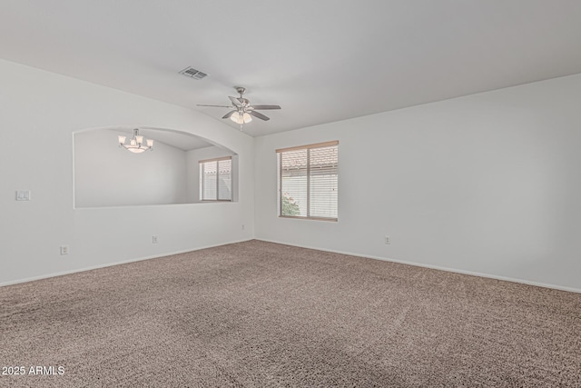 708 E Mule Train Trl, San Tan Valley, AZ 85143 - carpeted spare room featuring arched walkways, baseboards, visible vents, and ceiling fan with notable chandelier