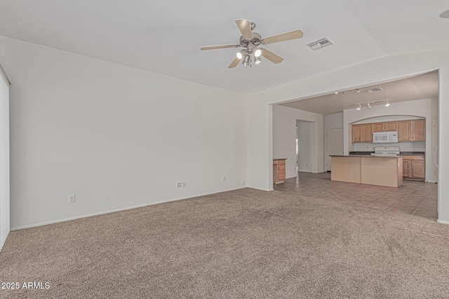 708 E Mule Train Trl, San Tan Valley, AZ 85143 - unfurnished living room featuring baseboards, visible vents, a ceiling fan, and light colored carpet