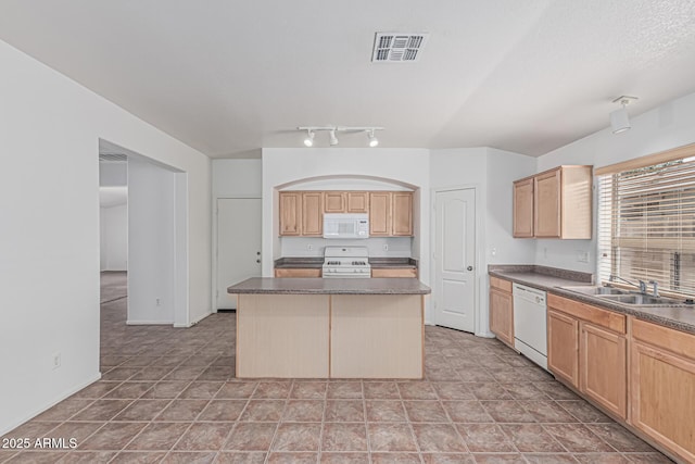 708 E Mule Train Trl, San Tan Valley, AZ 85143 - kitchen with visible vents, dark countertops, a center island, a sink, and white appliances