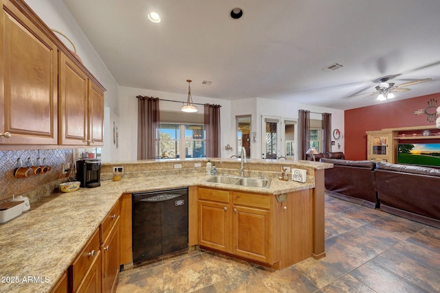 kitchen featuring kitchen peninsula, ceiling fan, sink, black dishwasher, and hanging light fixtures