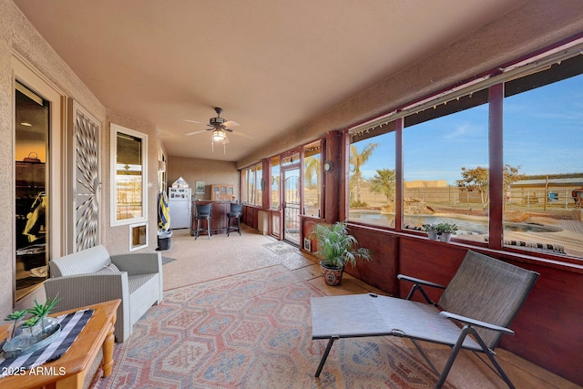 sunroom featuring ceiling fan