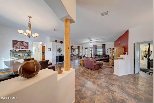 living room with ceiling fan with notable chandelier