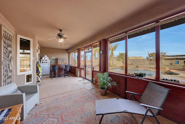 sunroom / solarium with ceiling fan