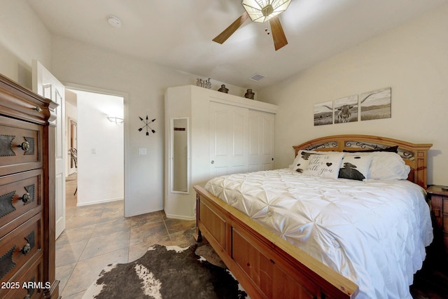 bedroom with ceiling fan and a closet