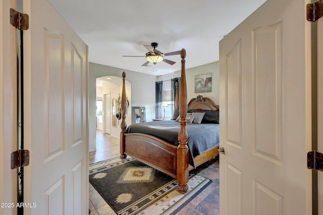 tiled bedroom with ceiling fan