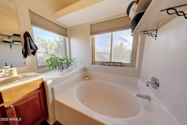 bathroom featuring vanity and a relaxing tiled tub