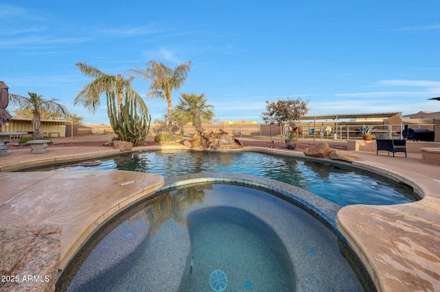 view of pool featuring an in ground hot tub