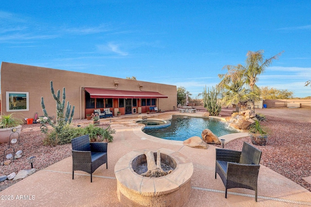 view of swimming pool with an in ground hot tub, a patio, and a fire pit