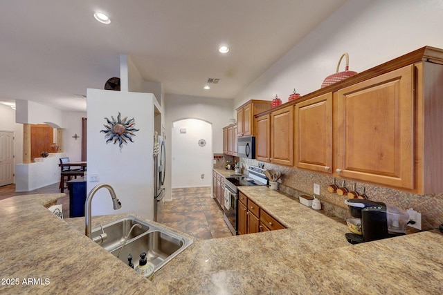 kitchen featuring decorative backsplash, stainless steel appliances, and sink