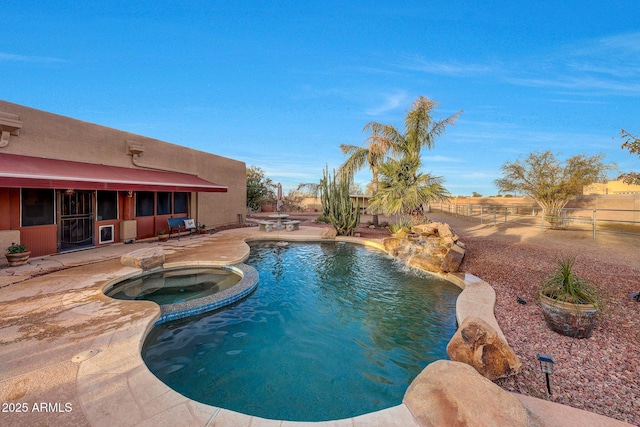 view of pool featuring a patio area and an in ground hot tub