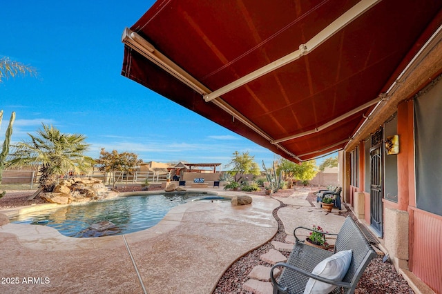 view of swimming pool featuring pool water feature and a patio area