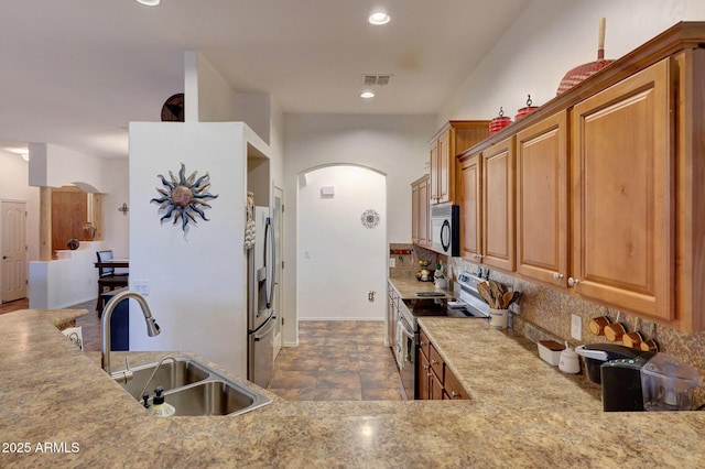 kitchen featuring decorative backsplash, sink, and stainless steel appliances