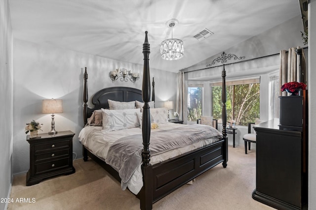 carpeted bedroom with a chandelier and lofted ceiling