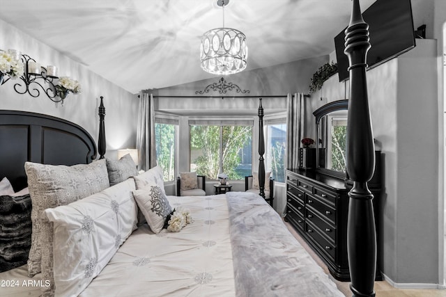 bedroom featuring a chandelier and lofted ceiling