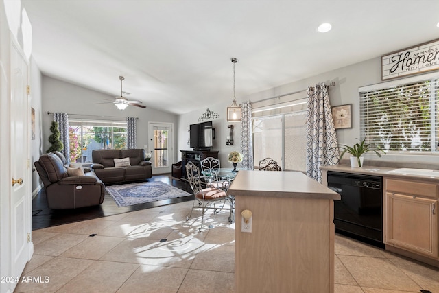 kitchen with pendant lighting, dishwasher, a center island, lofted ceiling, and light tile patterned floors